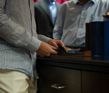 Person holding a wallet with a blurred background
