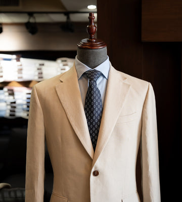 Beige suit on a mannequin with a blurred background