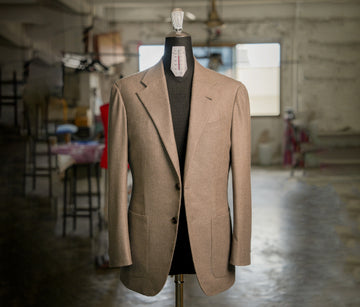Brown suit jacket on a mannequin in an industrial setting