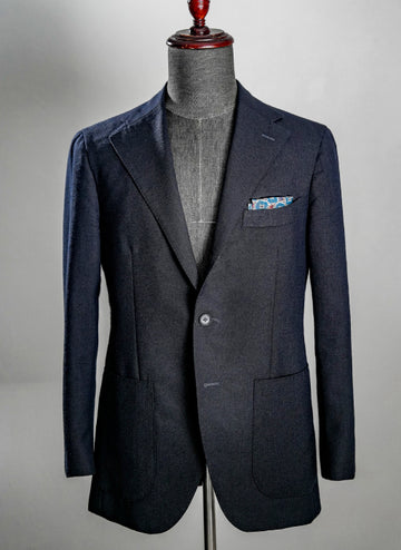 Navy blazer on a mannequin against a gray background