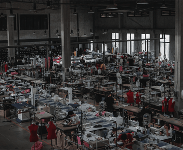 Factory interior with numerous workers and machinery