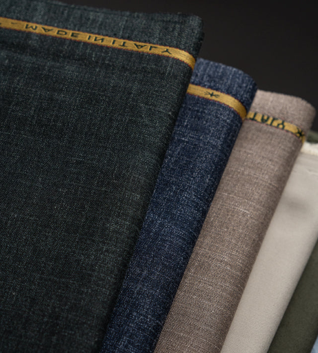 Four rolls of fabric in different colors with 'Made in Italy' label.