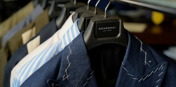 Clothing on hangers with a visible brand label in a store setting