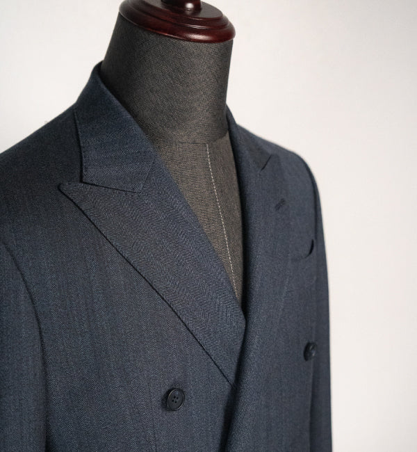 Gray suit jacket on a mannequin against a white background