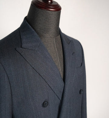 Gray suit jacket on a mannequin against a white background