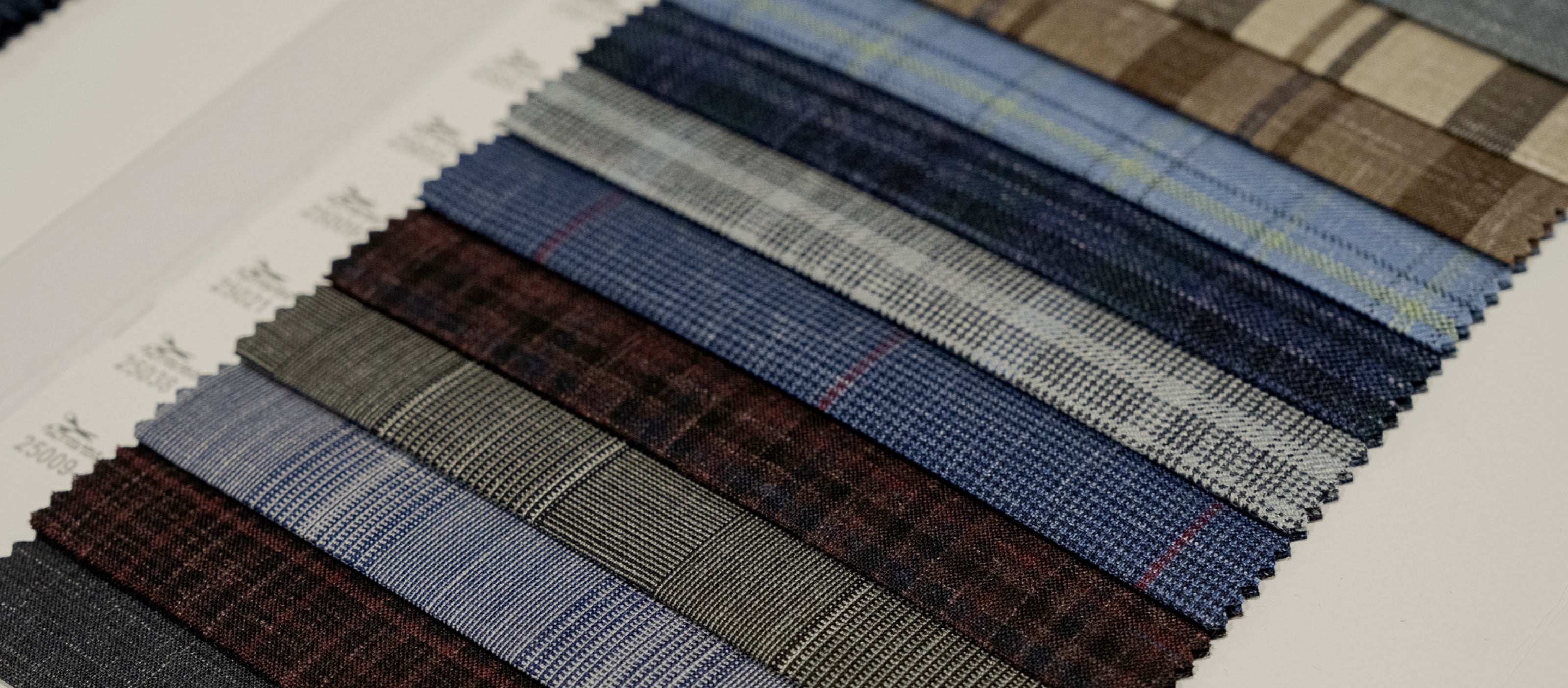 Fabric swatches in various plaid patterns and colors.