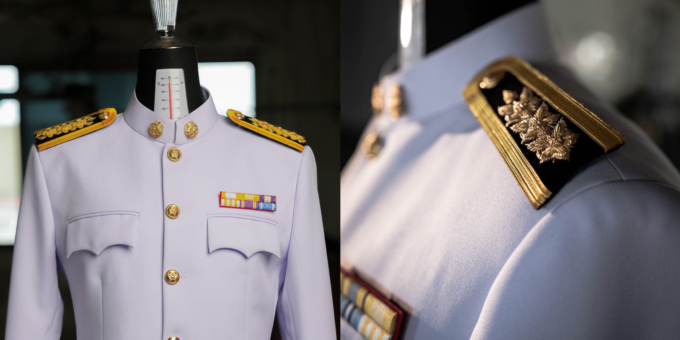 Formal uniform with gold accents on a mannequin against a blurred background